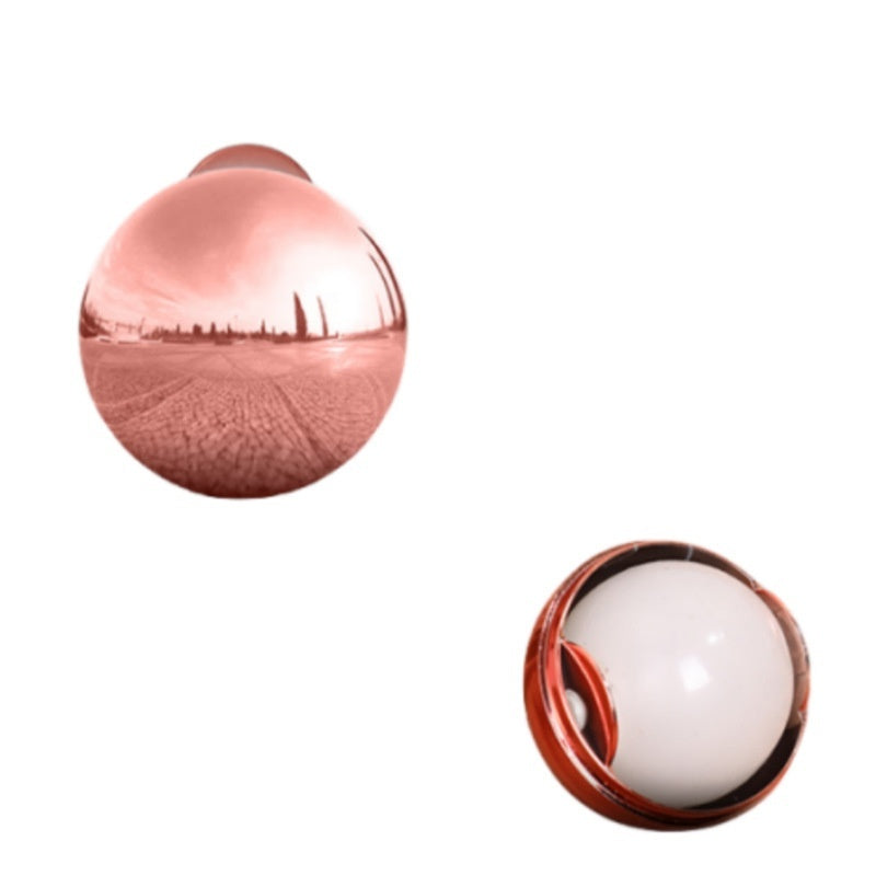 Rose gold spherical object with a white interior on a white background