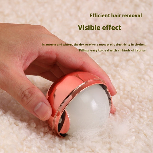 Hand holding a small device on a textured surface with text about hair removal and static electricity.