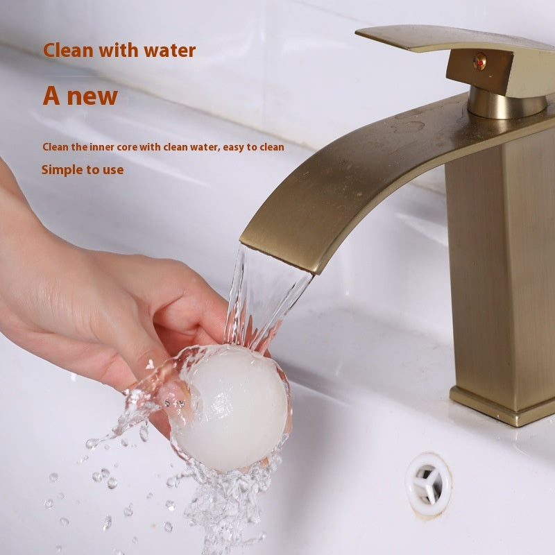 Gold faucet with water flowing, hand washing the tool, on a white background.