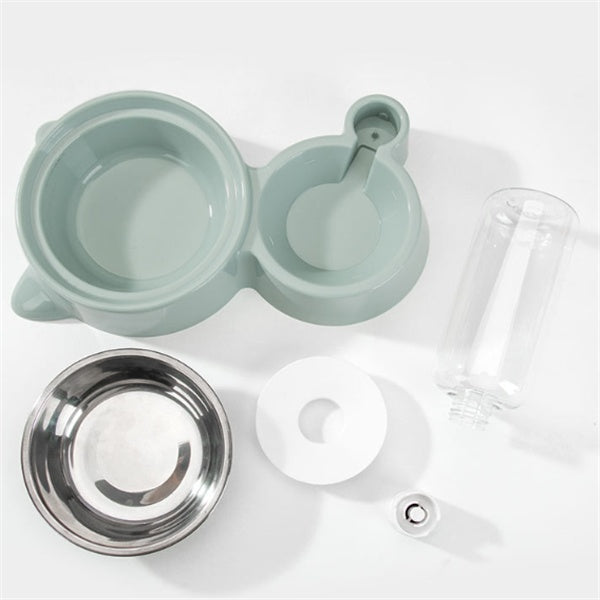 Tea-making set with green teapot, clear glass carafe, and metal strainer on a white background