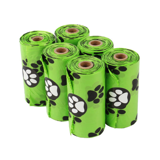 Green rolls of dog waste bags with paw prints on a white background