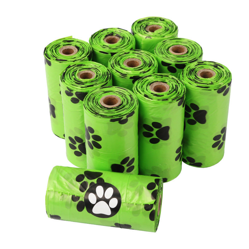 Green rolls of dog waste bags with black paw prints on a white background