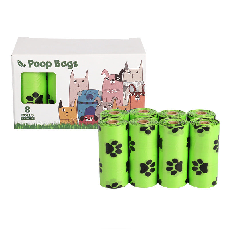 Green rolls of dog poop bags with a packaging box featuring cartoon dogs on a white background.