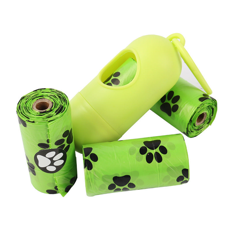 Green pet waste bags with a yellow dispenser on a white background