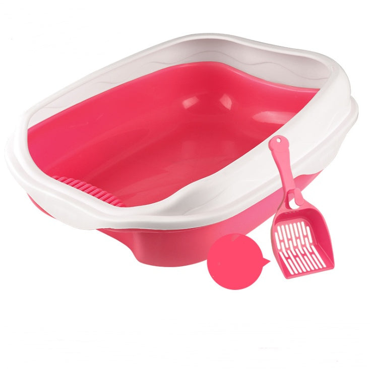 Pink pet litter box with a scoop on a white background