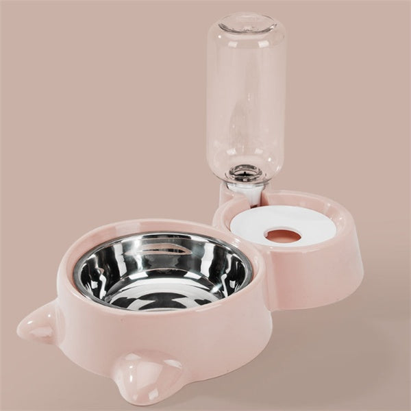 Pink pet bowl and water bottle set on a beige background
