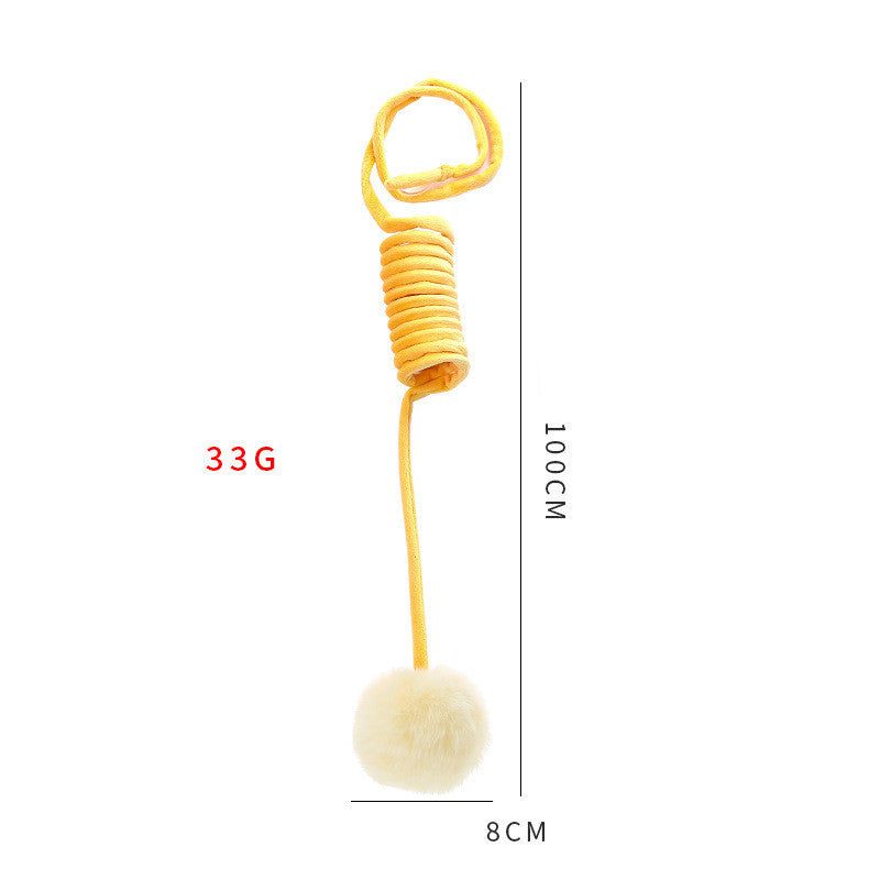 Yellow spring with a white pom-pom attached, showing measurements on a white background.