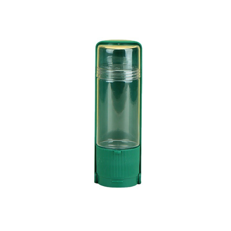 Green cylindrical container with clear top on a white background