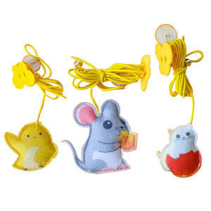 Three colorful toy animals with yellow strings on a white background