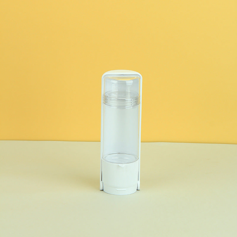 Clear plastic tube with white cap on a yellow and beige gradient background