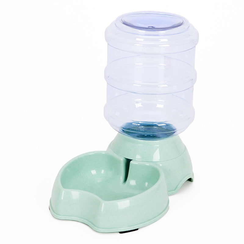 Pet water and food dispenser with a clear water container on a white background