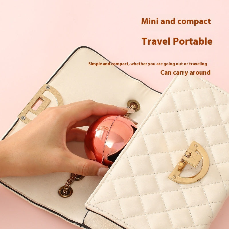 Hand holding a pink compact tool over a white quilted handbag with text about its portability.