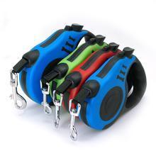 Set of four retractable dog leashes in blue, green, red, and black on a white background