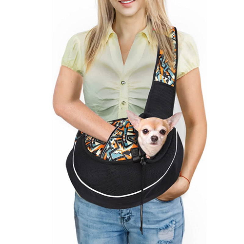 Woman holding a black pet sling with a small dog inside on a white background