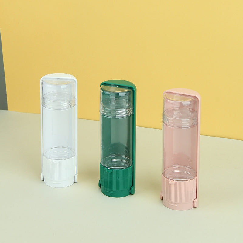 Three portable water bottles in white, green, and pink on a yellow and beige background