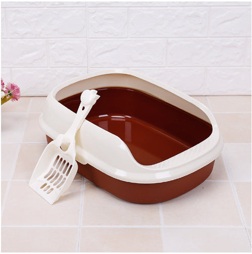 Cat litter box with a scoop on a tiled floor