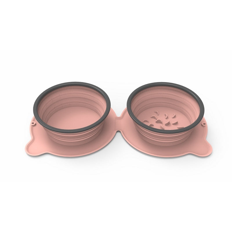 Pink collapsible pet bowls with black interior on a white background