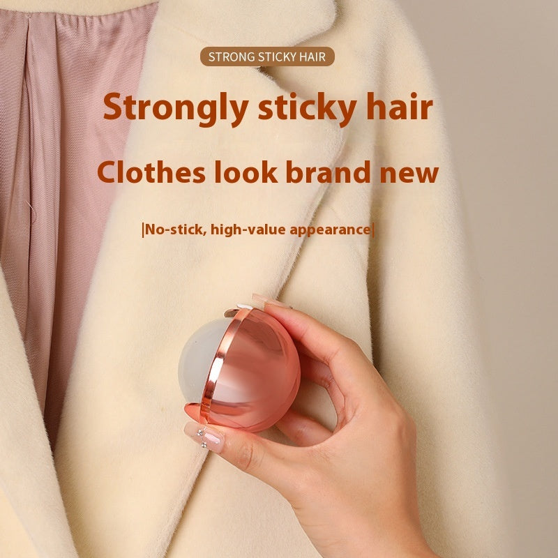 Hand holding a pink hair removal device against a beige fabric background with text about strong sticky hair removal.