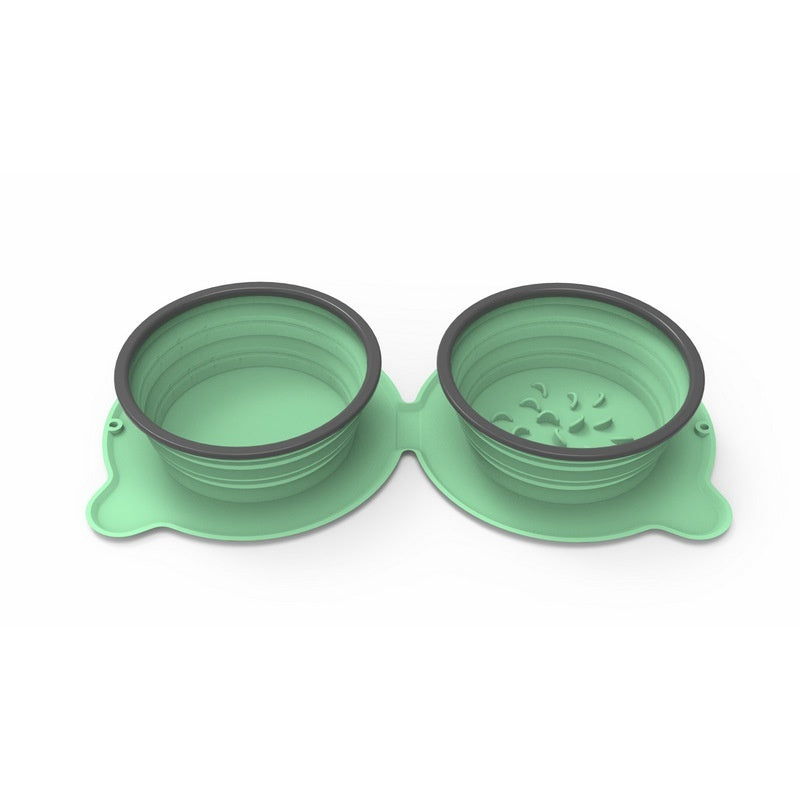 Green collapsible pet bowls with black rims on a white background