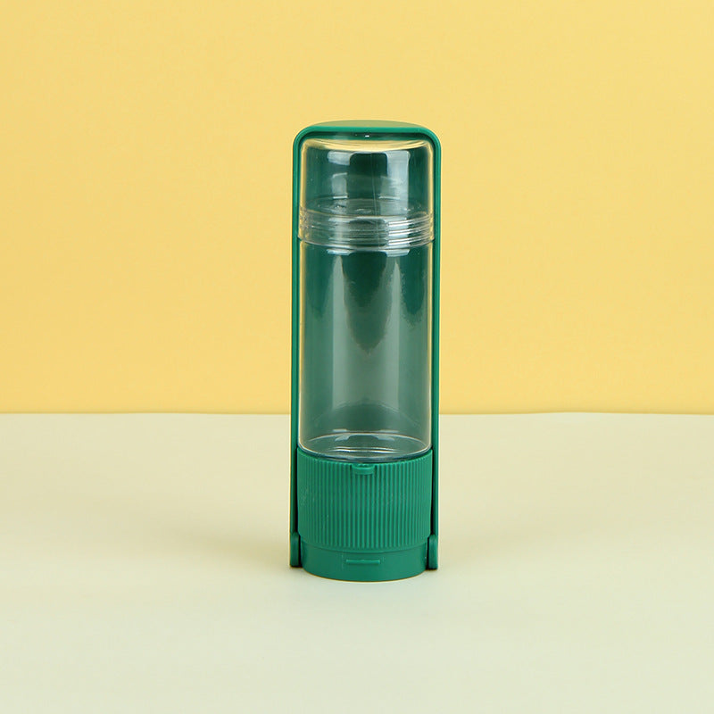 Green transparent container on a beige surface with a yellow background