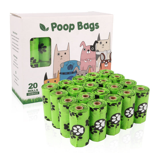 Green rolls of dog poop bags with a box featuring cartoon dogs on a white background