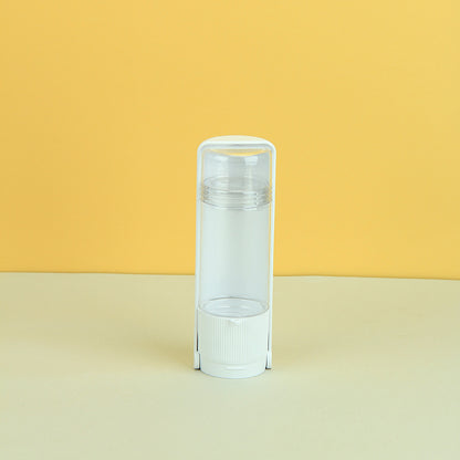 Clear plastic tube with white cap on a yellow and beige gradient background