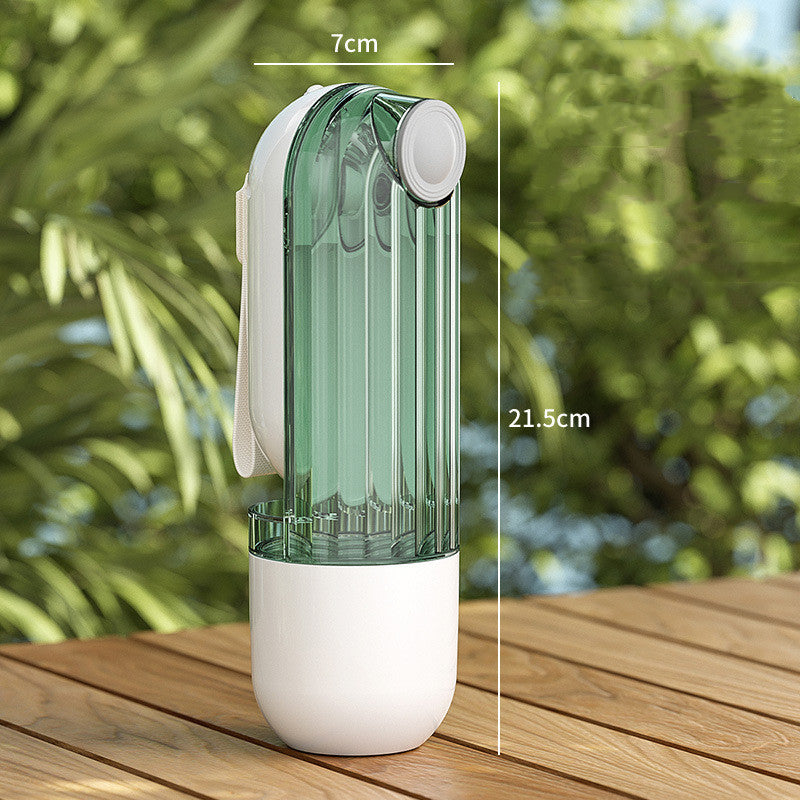 Green and white pet water bottle with measurements on a wooden surface and blurred green background