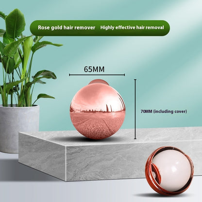 Rose gold hair remover with measurements on a light blue background