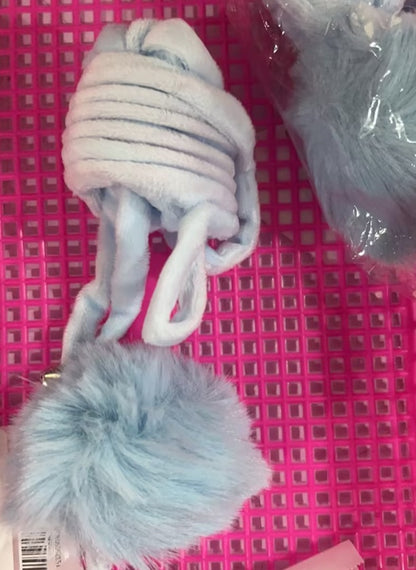 Pair of gray dog toys with pom-poms on a pink grid background