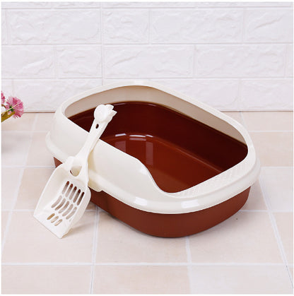 Cat litter box with a scoop on a tiled floor