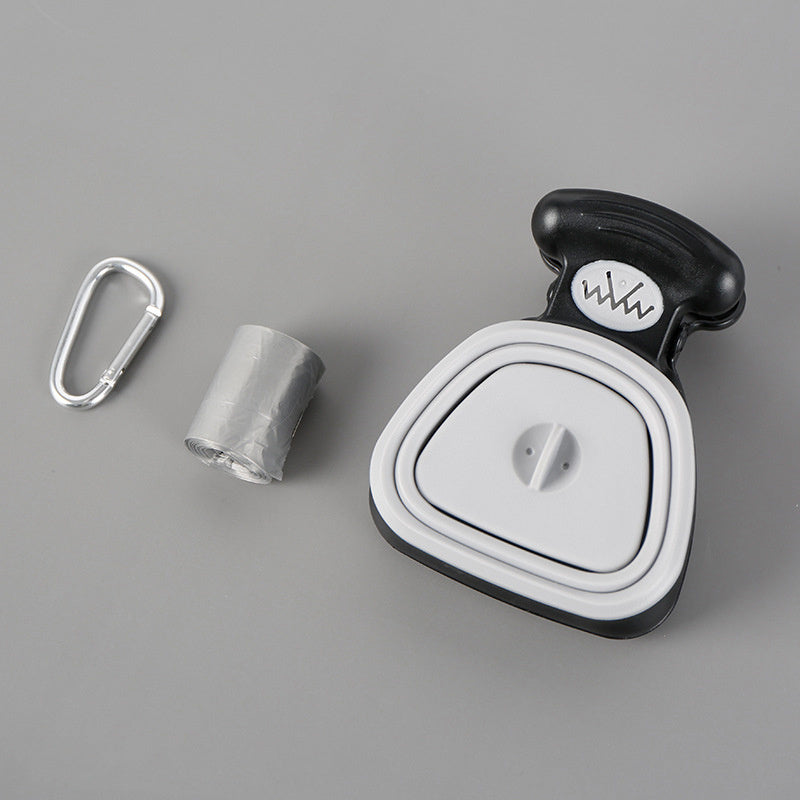 White and black device with carabiner and roll of tape on a gray background