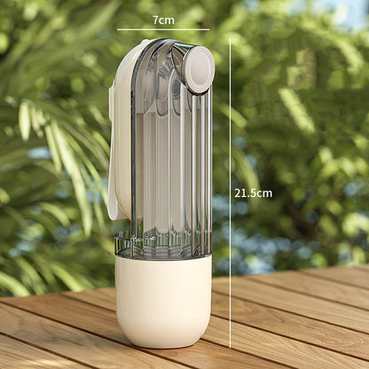 Transparent water bottle with beige base on a wooden surface, with measurements indicated.